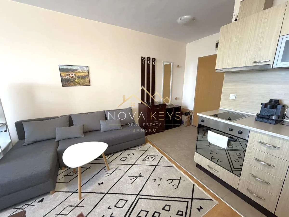 Open-plan living room with sectional sofa and kitchen, studio for rent in Razlog.