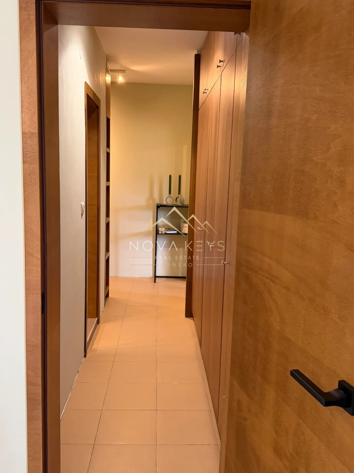 hallway with wood-paneled closets and beige tile floor, two-bedroom apartment for sale in Pirin Golf.