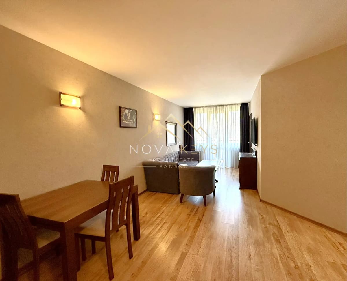 Living room with dining table and sofa, two-bedroom apartment for sale in the Bansko ski area.