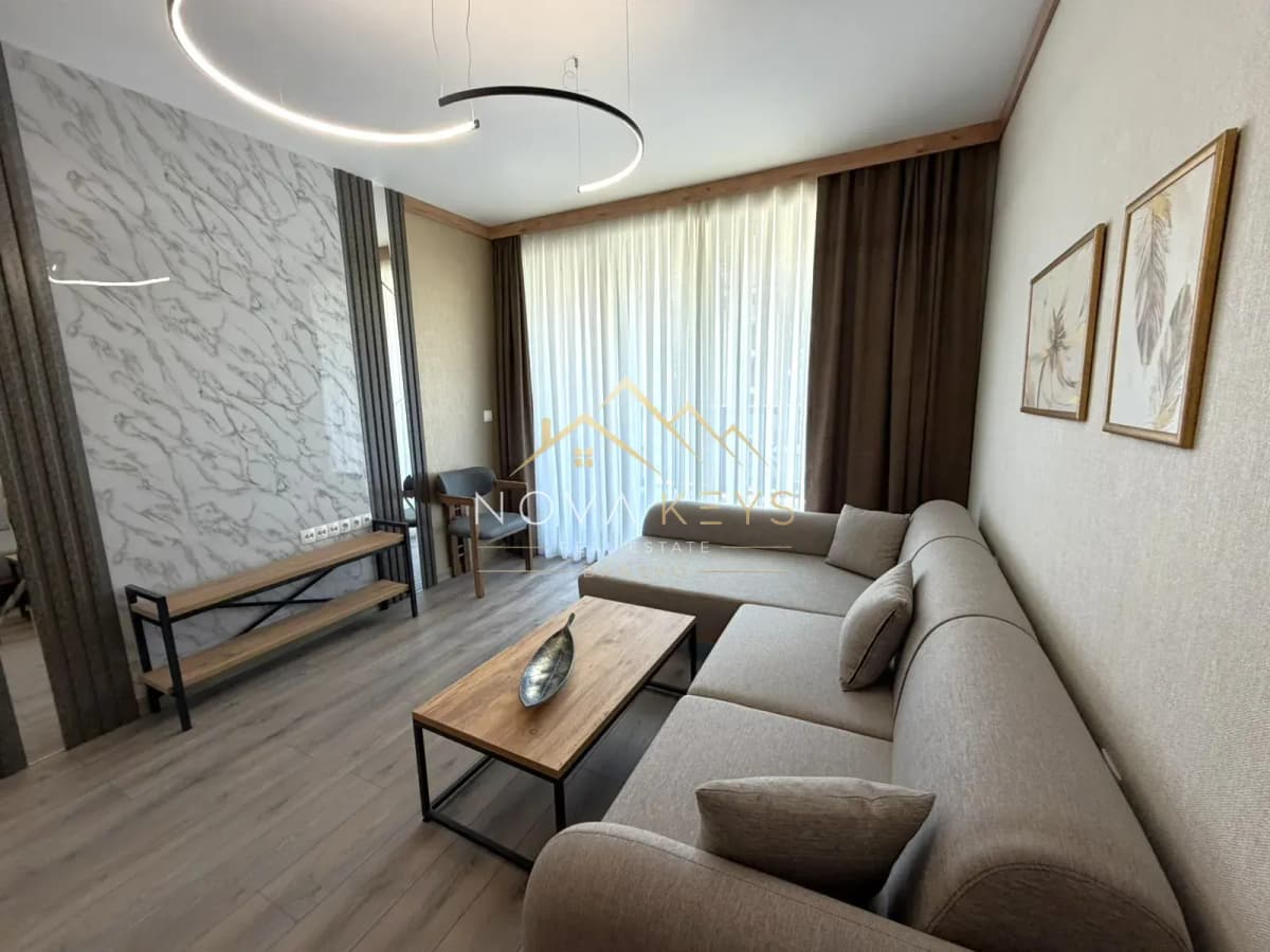 modern living room with sectional sofa and coffee table, three-bedroom apartment for sale in the Bansko ski area.
