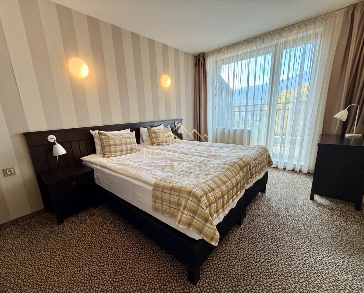 Bedroom with double bed and large window, house for sale in Dobrinishte.