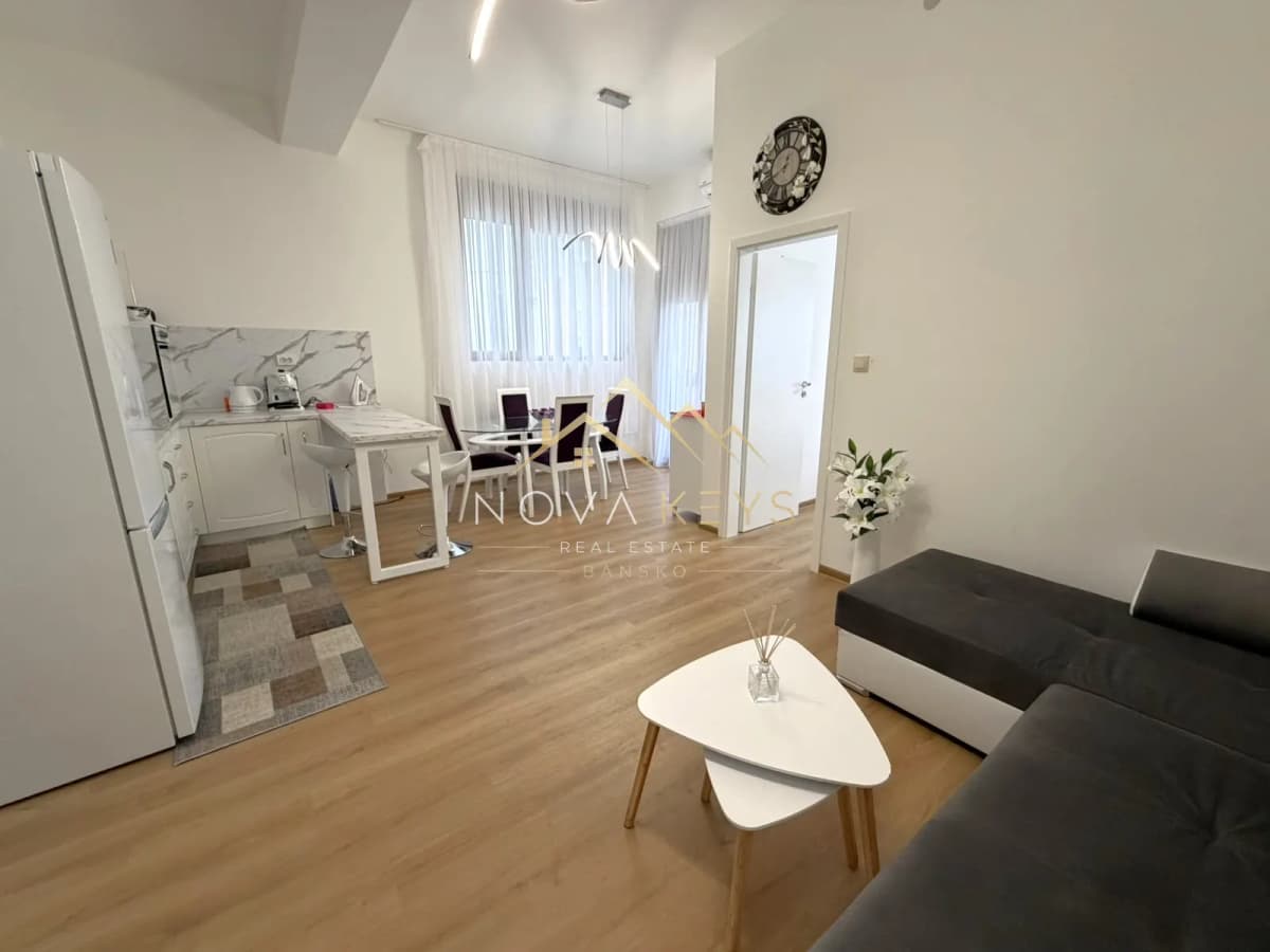 Open-plan living room with kitchen and dining area, two-bedroom apartment for sale in Pirin Golf.