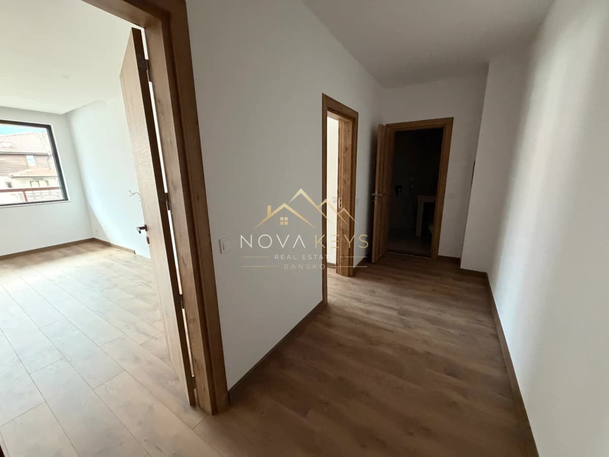 Empty hallway with wooden doors, two-bedroom apartment for sale in the Bansko ski area.