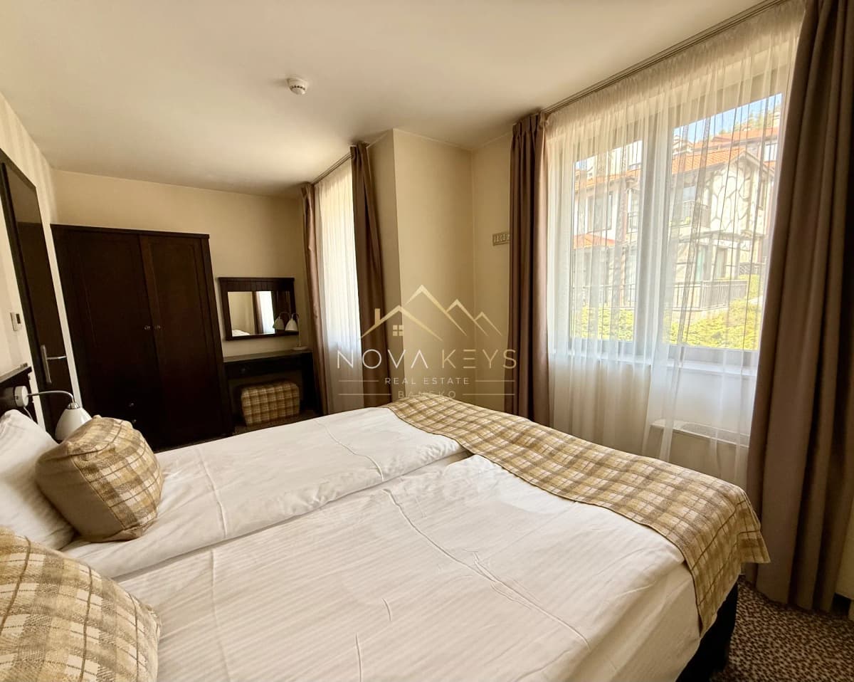 Bright bedroom with double bed and large windows, house for sale in Dobrinishte.