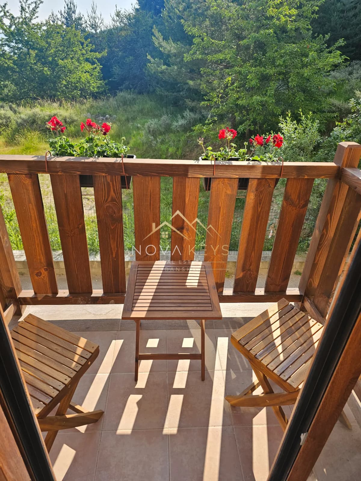 wooden balcony with chairs and table, studio for sale in the Bansko ski area.