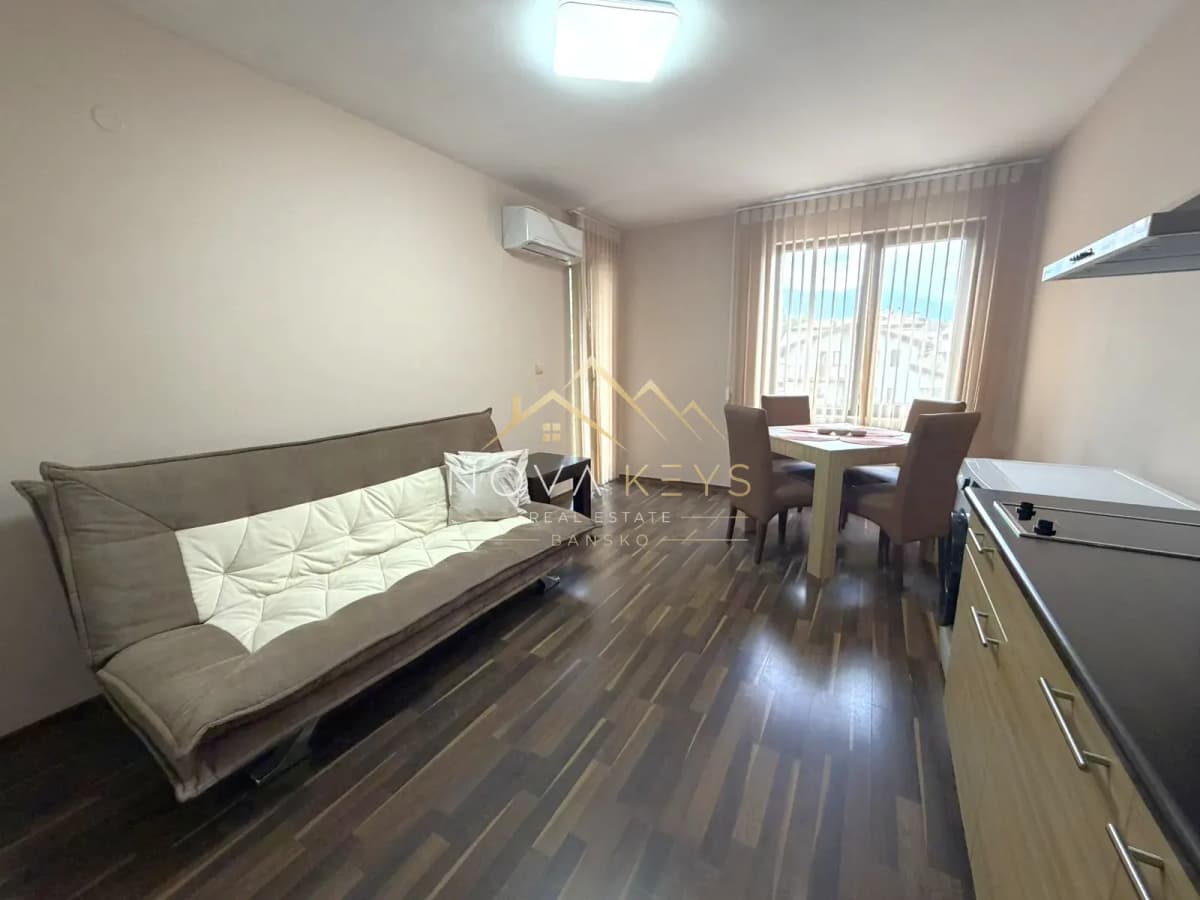 Furnished living dining room with sofa and table, three-bedroom apartment for rent in the Bansko ski area.