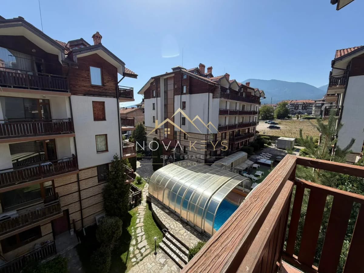 Balcony view over apartment buildings and covered pool, studio for rent in Bansko.