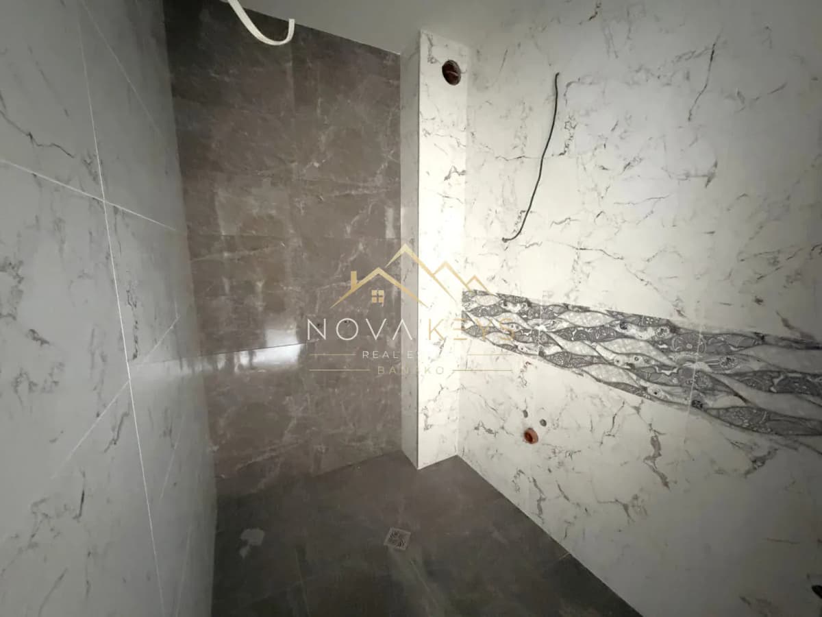 unfinished tiled shower area, two-bedroom apartment for sale in the Bansko ski area.