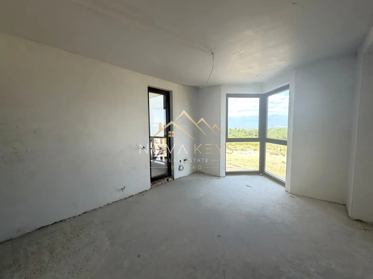 Unfinished room with corner window, three-bedroom apartment for sale in the Bansko ski area.