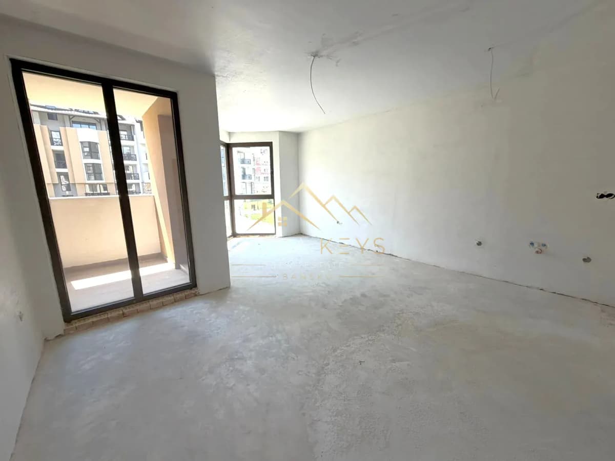 unfinished empty room with balcony doors, studio for sale in the Bansko ski area.
