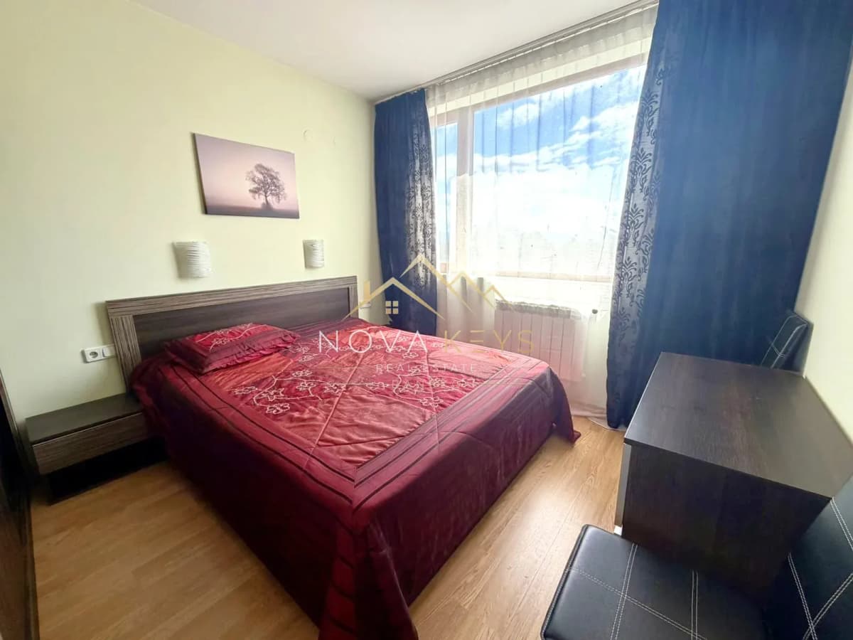 Bedroom with double bed and blue curtains, two-bedroom apartment for sale in Razlog.