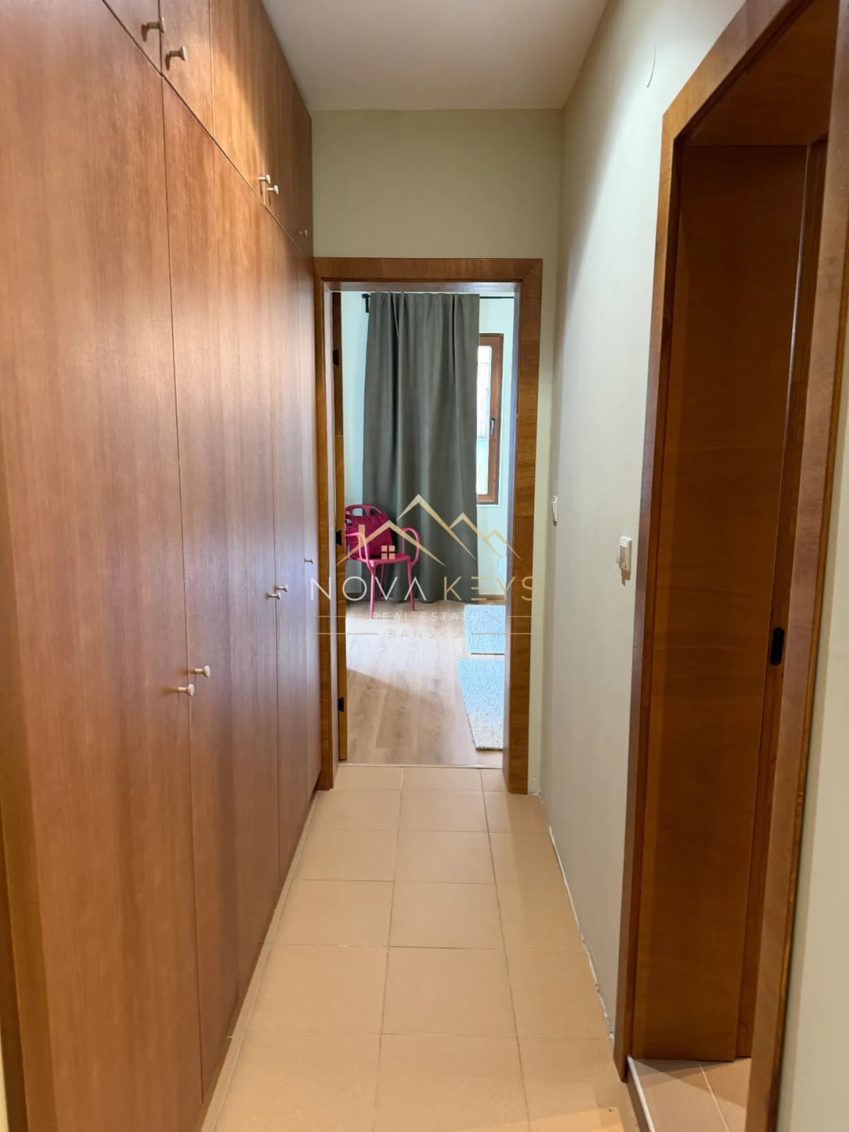 Narrow hallway with built-in wooden wardrobes, two-bedroom apartment for sale in Pirin Golf.
