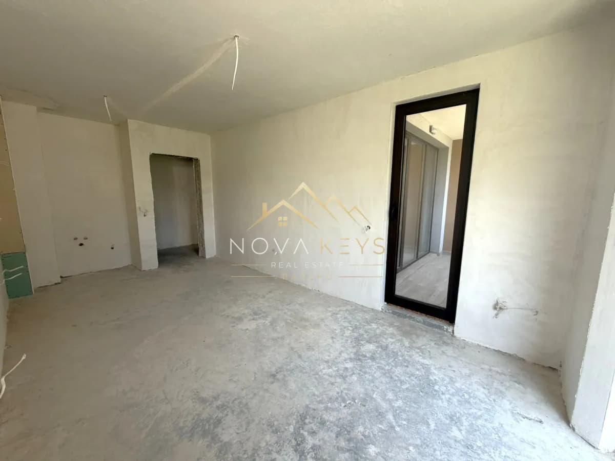 unfinished room with glass door, two-bedroom apartment for sale in the Bansko ski area.