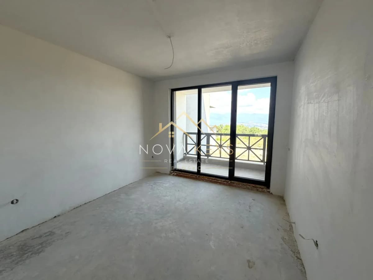 unfinished room with sliding glass door, three-bedroom apartment for sale in the Bansko ski area.