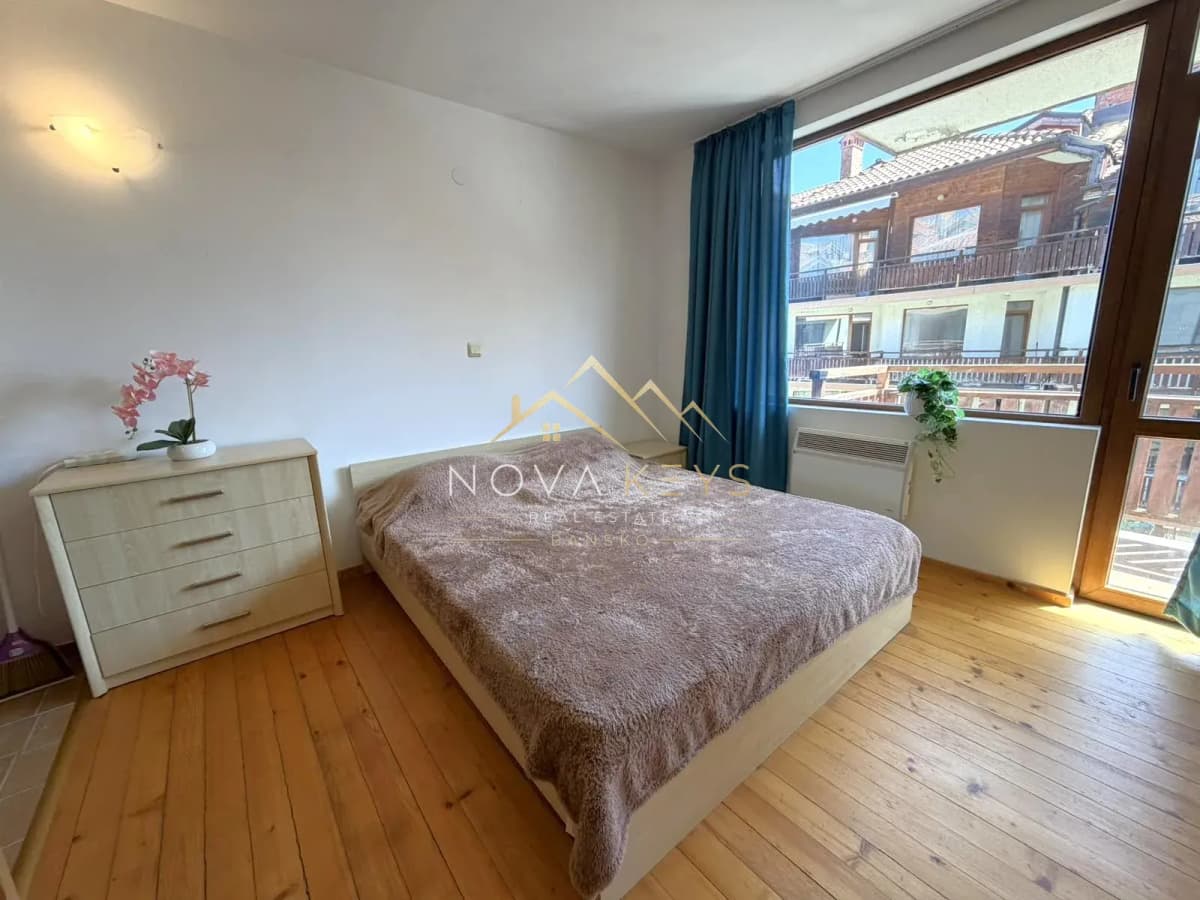 Bedroom with double bed and large window, studio for rent in Bansko.
