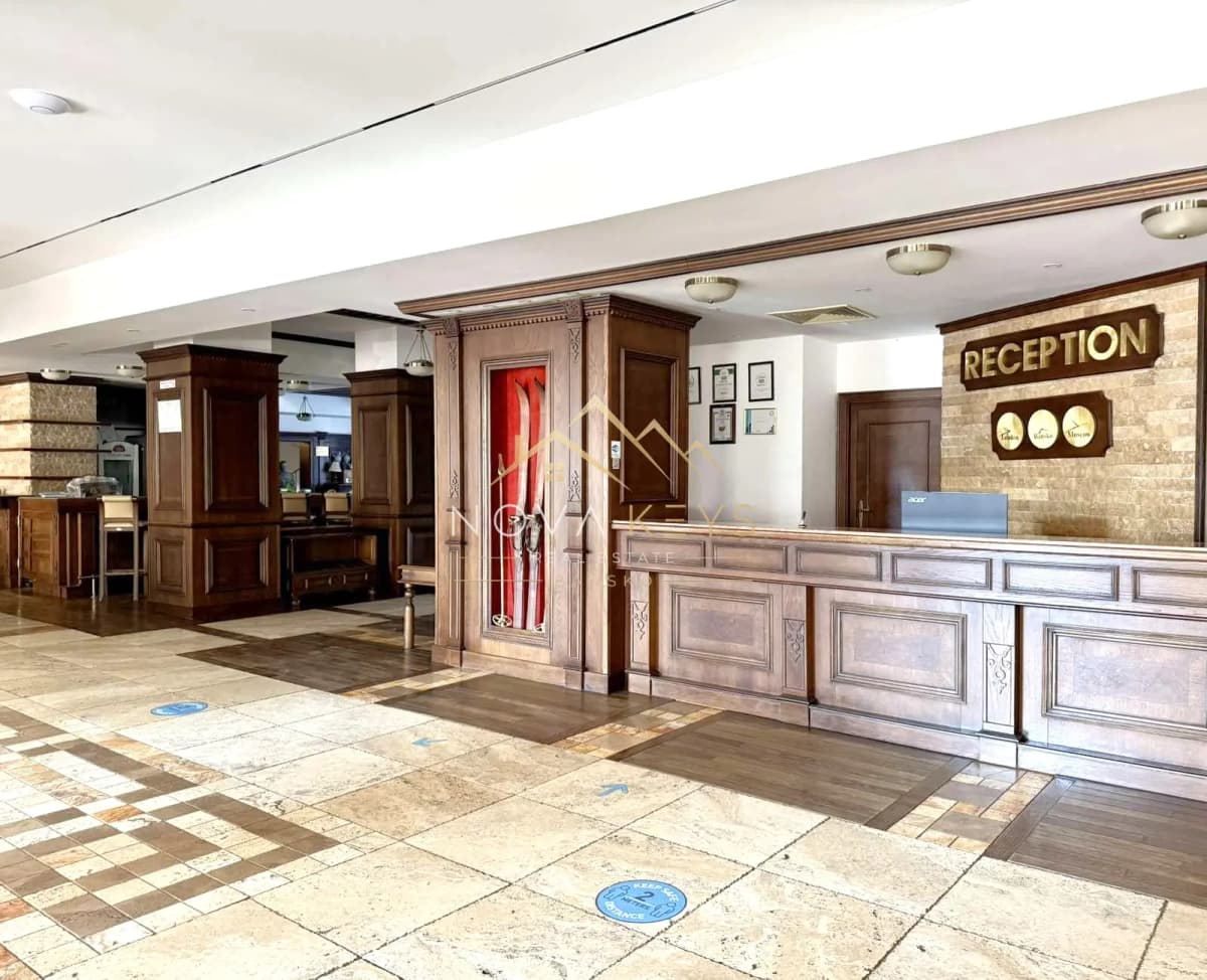 Reception lobby with wooden desk, two-bedroom apartment for sale in the Bansko ski area.