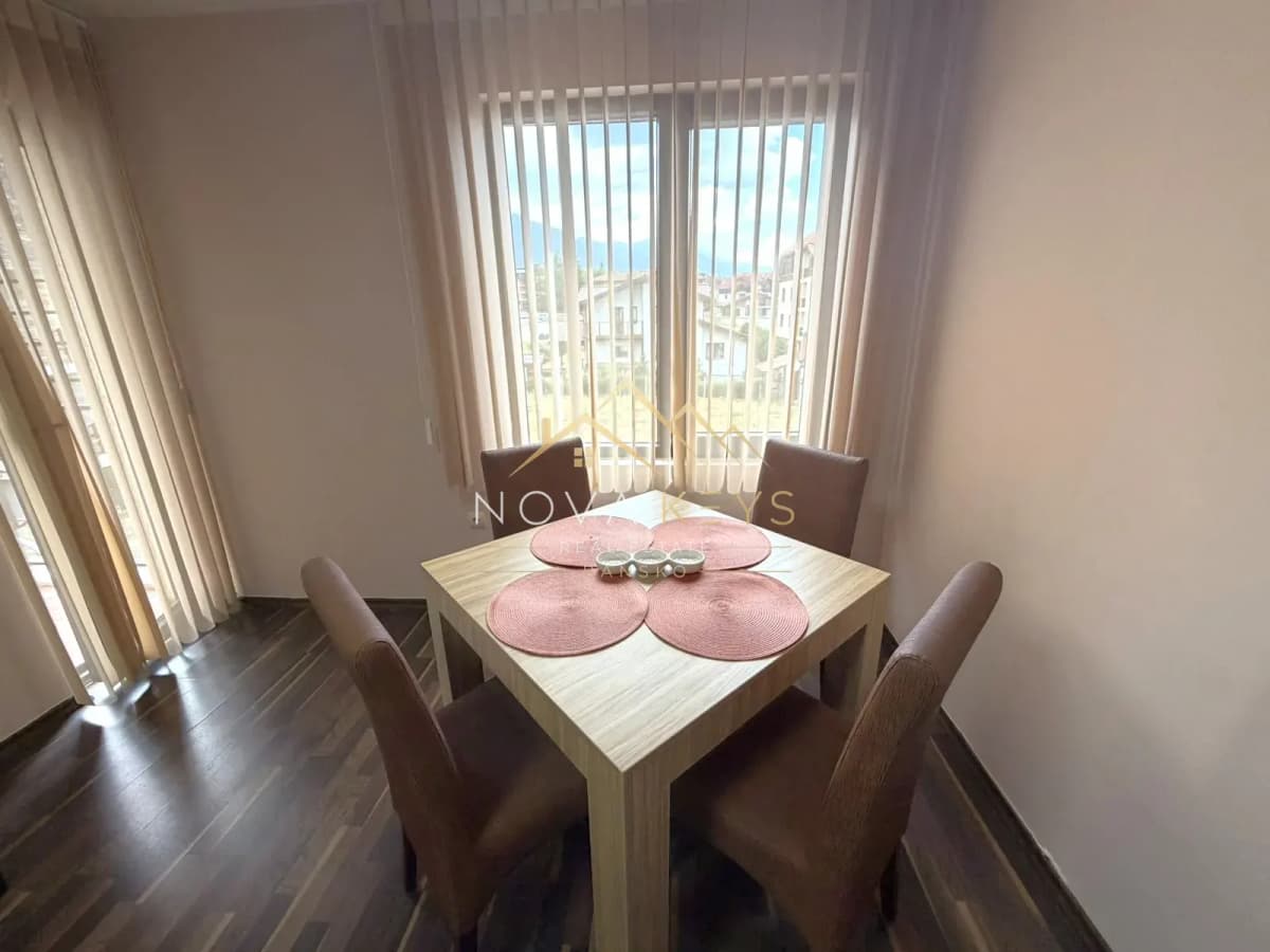 Dining nook with square table and four chairs, three-bedroom apartment for rent in the Bansko ski area.