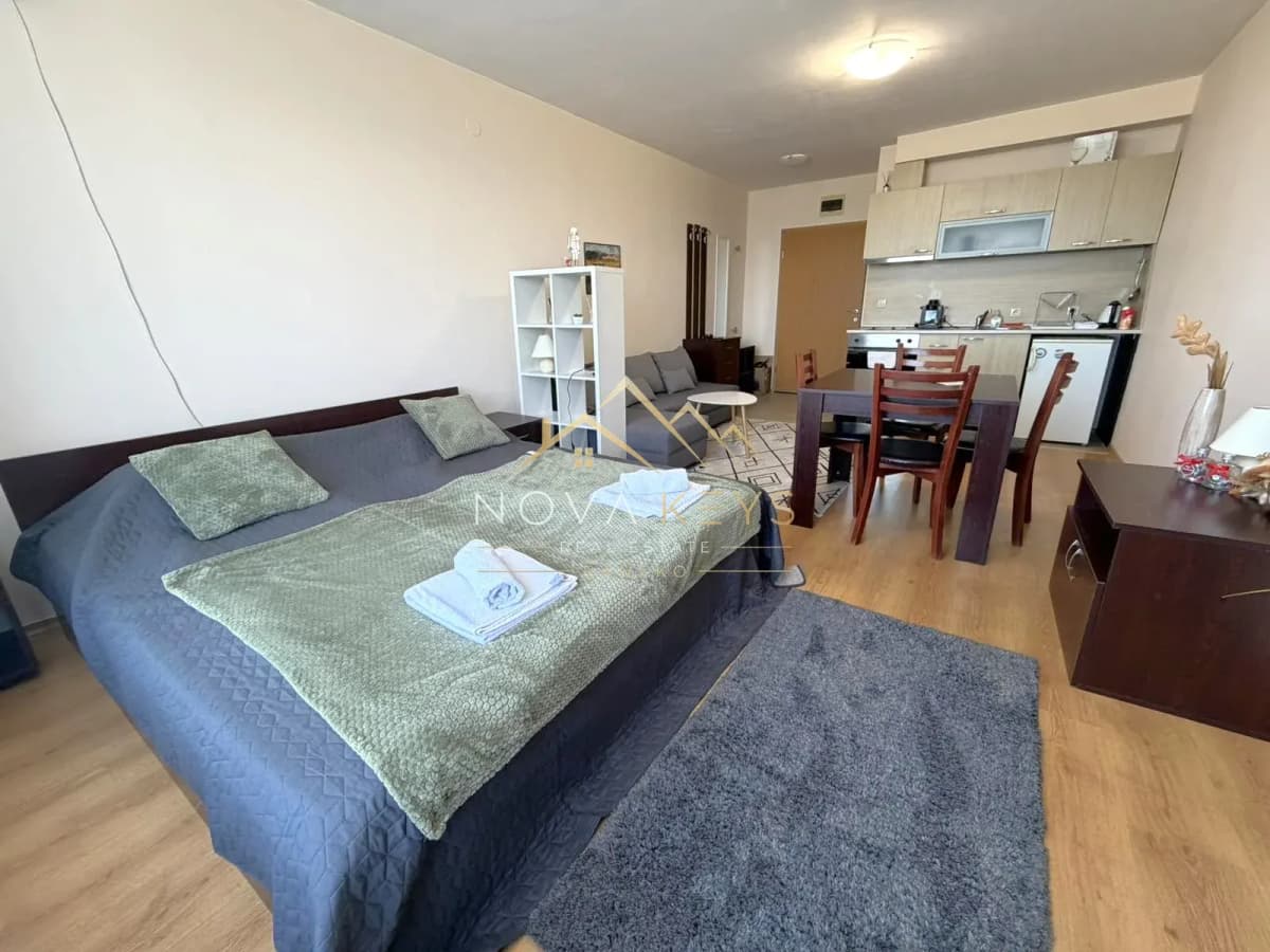 Studio apartment interior with bed, dining table, and kitchenette, studio for rent in Razlog.